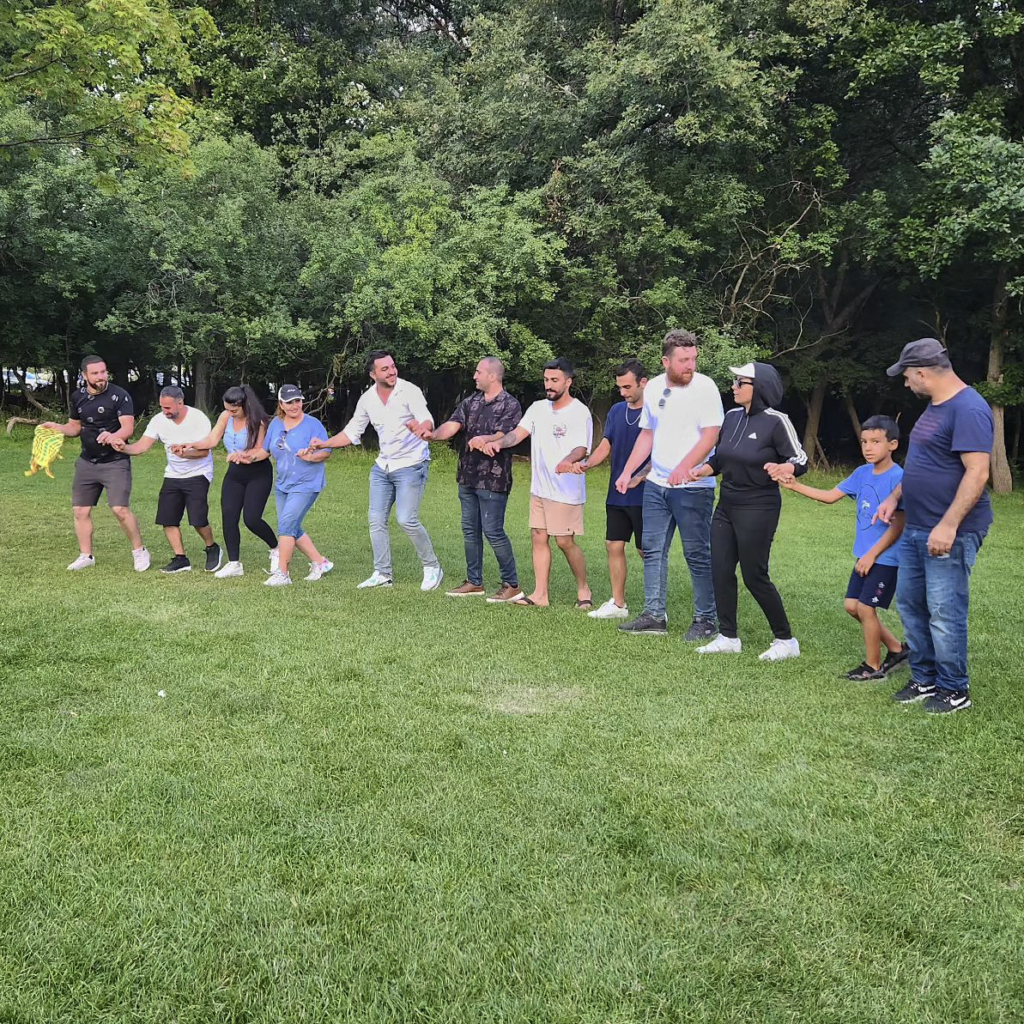 Members of the Kurdish community dance to Kurdish music while attending one of the many summer picnics organized by the Kurdish Cultural Center of Illinois in Chicago, Ill., July 2023. Photo courtesy of the Kurdish Cultural Center of Illinois